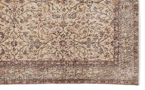 Load image 1 in gallery view. Beige and brown traditional rug with a distressed floral medallion pattern and a wide decorative border.