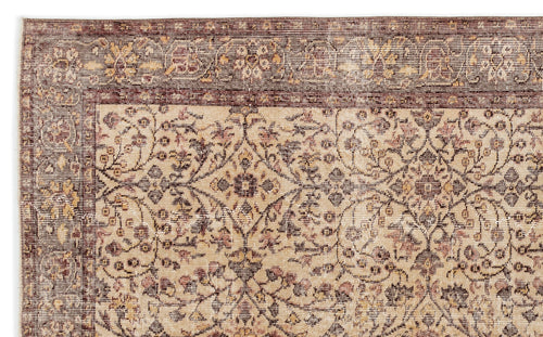 Load image 1 in gallery view. Beige and brown traditional rug with a distressed floral medallion pattern and a wide decorative border.
