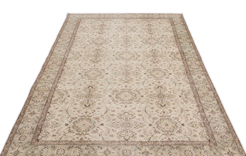 Load image 1 in gallery view. The Glela - Vintage Floral Rug (5'0 x 8'11) is a rectangular beige Anatolian hand-woven piece with an intricate floral and geometric pattern, decorative border, and subtle cream, taupe, and light brown hues.