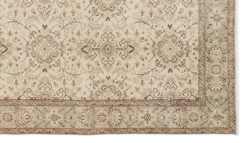 Load image 1 in gallery view. A close-up of the Glela - Vintage Floral Rug (5'0 X 8'11) in beige and light brown, showcasing floral and geometric patterns with a decorative border and vintage-inspired intricate details.