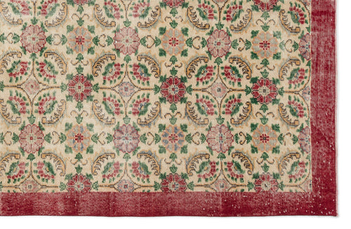 Load image 1 in gallery view. Beige rug with a repeating floral medallion pattern in red, green, and gold, featuring a wide red border.