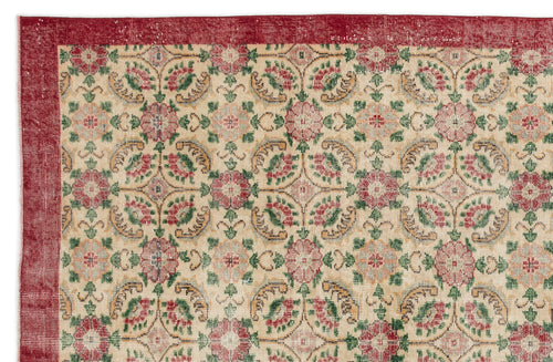 Load image 1 in gallery view. Beige rug with a red border and a repeating floral medallion pattern in red, green, and gold.