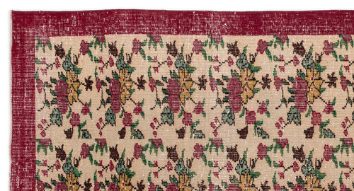 Load image 1 in gallery view. Beige rug with a red border and a repeating floral pattern in red, yellow, and green on a white background.