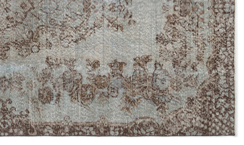 Load image 1 in gallery view. Light blue and brown rug with a distressed floral medallion pattern and a wide decorative border.