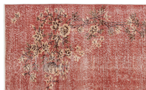 Load image 1 in gallery view. Terracotta rug with a distressed floral pattern in cream and dark brown.