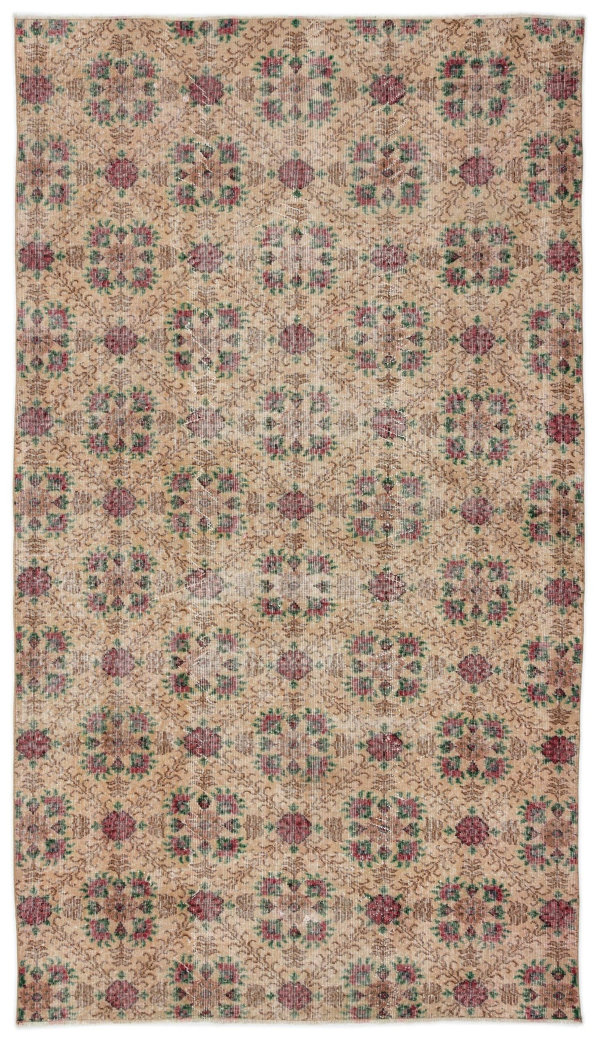 Tan vintage-style rug with a repeating floral medallion pattern in muted red and green on a white background.