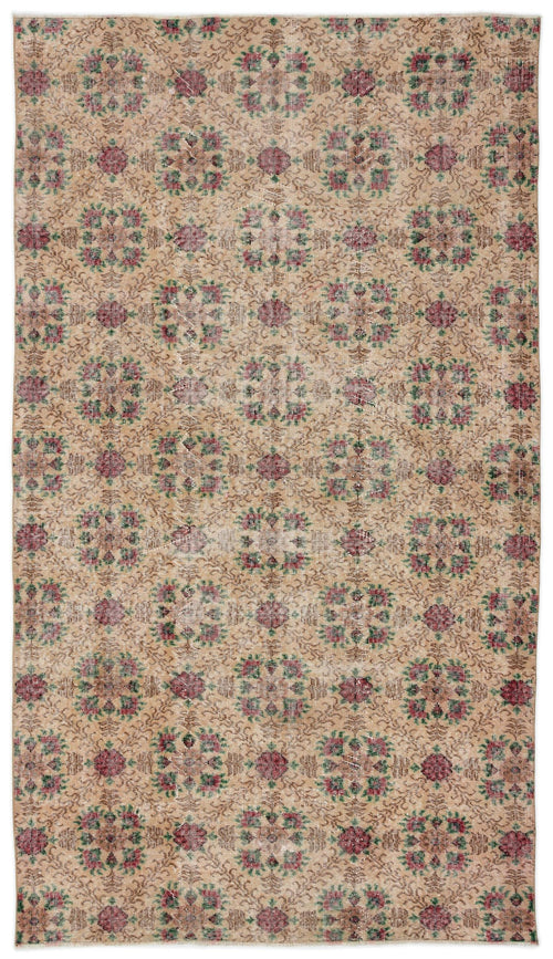 Load image 1 in gallery view. Tan vintage-style rug with a repeating floral medallion pattern in muted red and green on a white background.