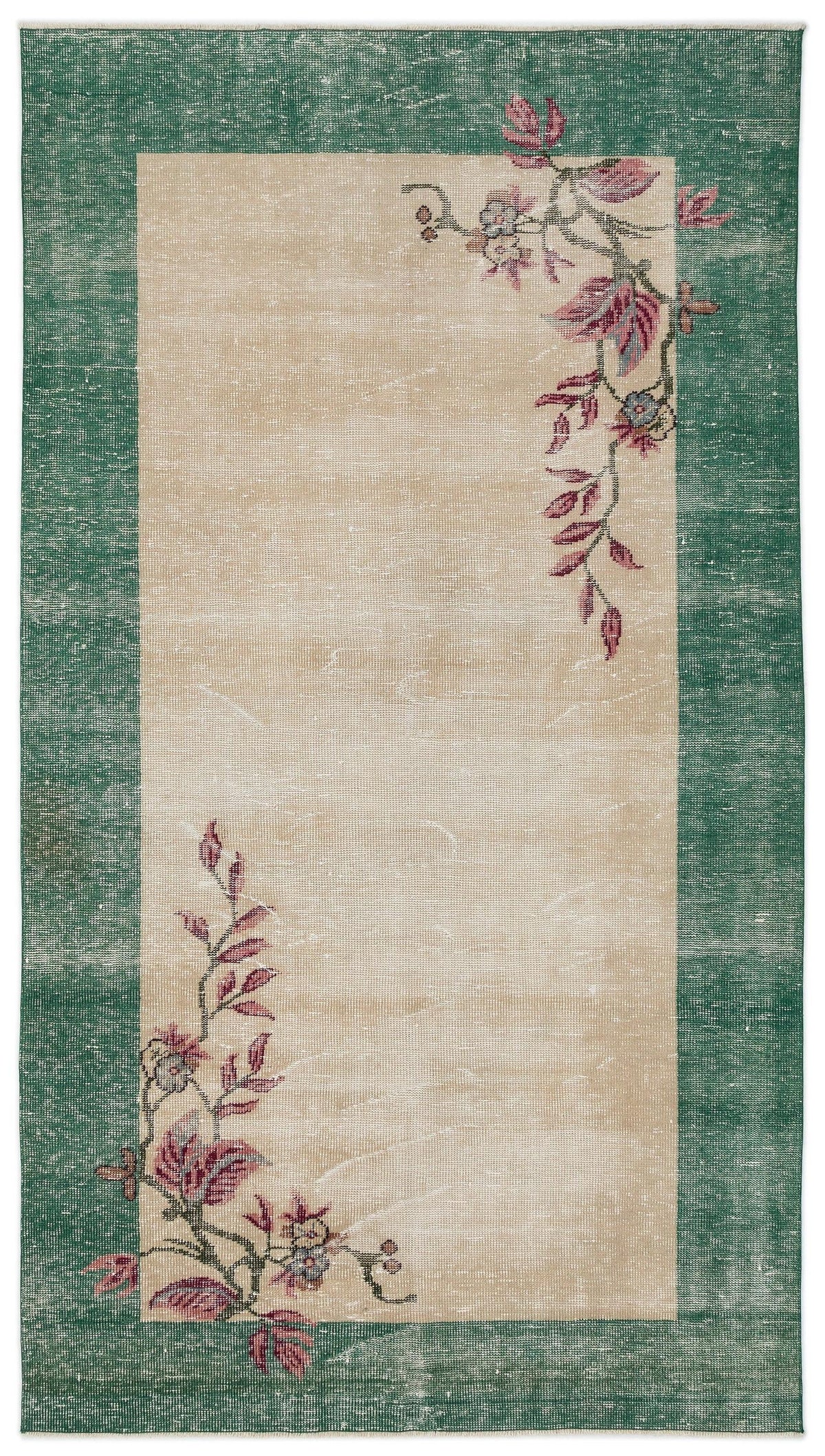 Beige rug with a wide green border and distressed floral vine motifs in pink and blue.