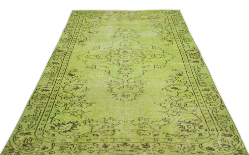 Load image 1 in gallery view. Lime green distressed rug with a dark brown traditional floral medallion and border pattern.