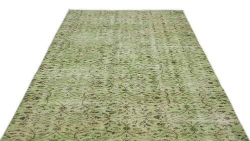 Load image 1 in gallery view. Sage green distressed rug with a dark brown repeating floral medallion pattern on a white background.