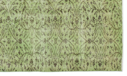Load image 1 in gallery view. Sage green rug with a distressed brown diamond lattice pattern and intricate floral motifs.