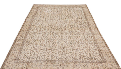Load image 1 in gallery view. The Pavia - Vintage Floral Rug (5'7 x 9'5) is a beige and light brown Anatolian hand-woven piece with detailed floral and vine motifs and a decorative border, shown on a white background.