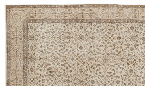 Load image 1 in gallery view. A close-up of the Pavia - Vintage Floral Rug (5'7 x 9'5), a beige and light brown Anatolian hand-woven piece with an intricate symmetrical floral and vine design, subtle distressed texture, and decorative border.