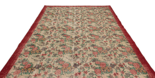 Load image 1 in gallery view. Beige vintage-style rug with a red border and an all-over floral pattern in red, green, and muted tones.