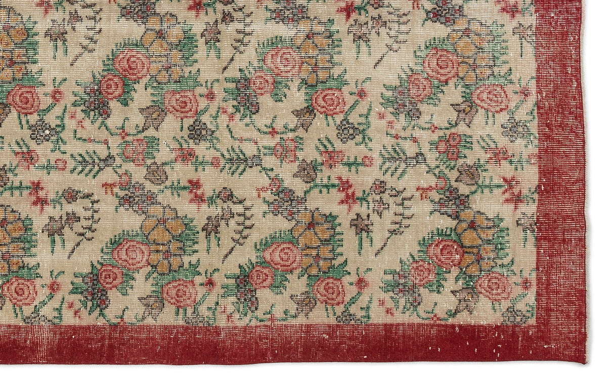 Beige rug with a distressed floral pattern in red, green, and yellow, featuring a solid red border.