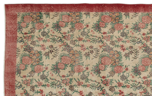 Load image 1 in gallery view. Beige rug with a red border and a repeating floral pattern in red, green, and dark grey.