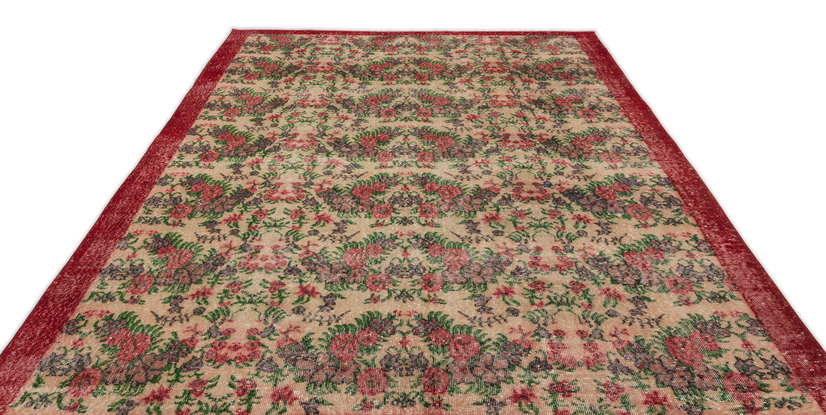 Beige vintage-style rug with a red floral pattern and a wide red border on a white background.