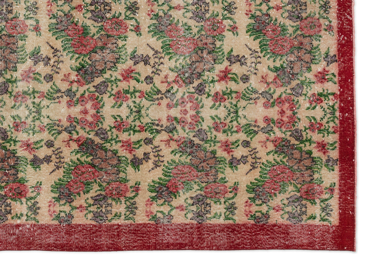 Beige rug with a distressed floral pattern in red, green, and dark purple, featuring a solid red border.