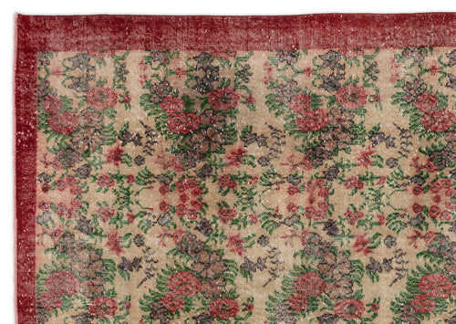 Load image 1 in gallery view. Beige rug with a distressed floral pattern in red, green, and dark purple, featuring a solid red border.