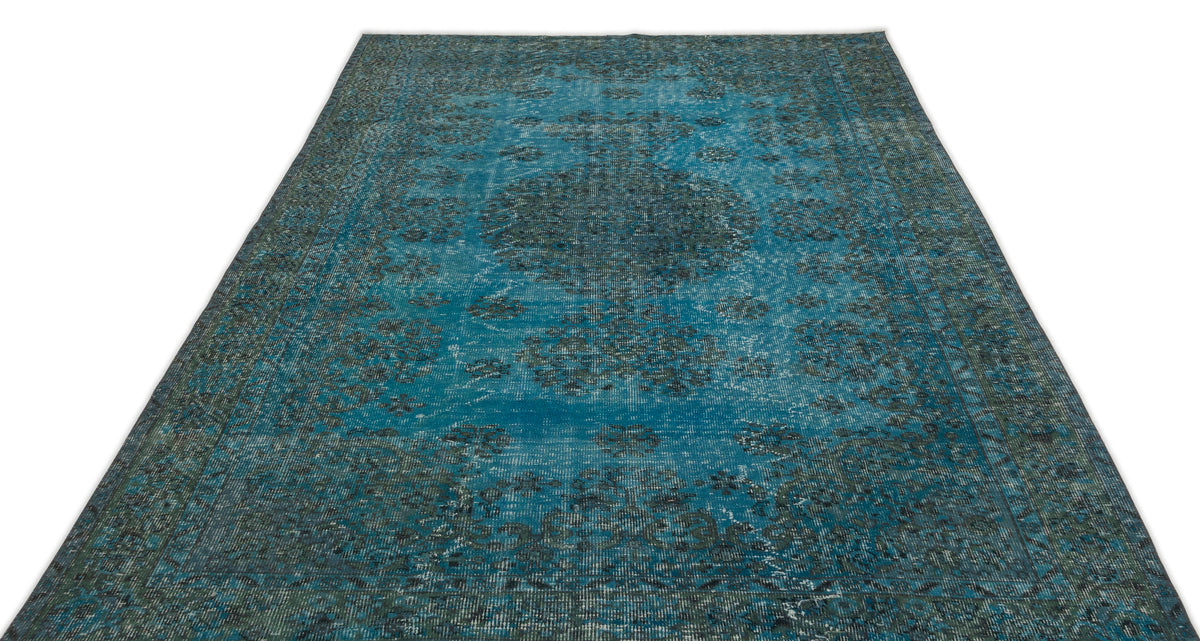 Teal and dark grey distressed rug with a traditional central medallion pattern on a white background.