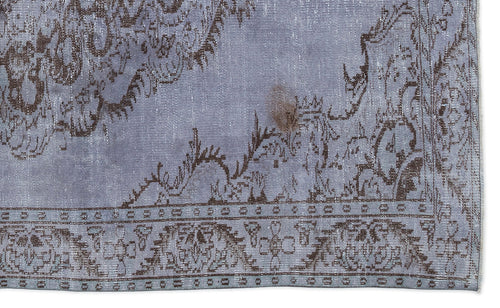 Load image 1 in gallery view. Periwinkle and dark brown distressed rug with a traditional floral medallion pattern and a geometric border.