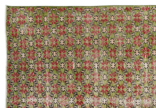 Load image 1 in gallery view. Green rug with a repeating red floral medallion pattern outlined in black and beige geometric lattice.