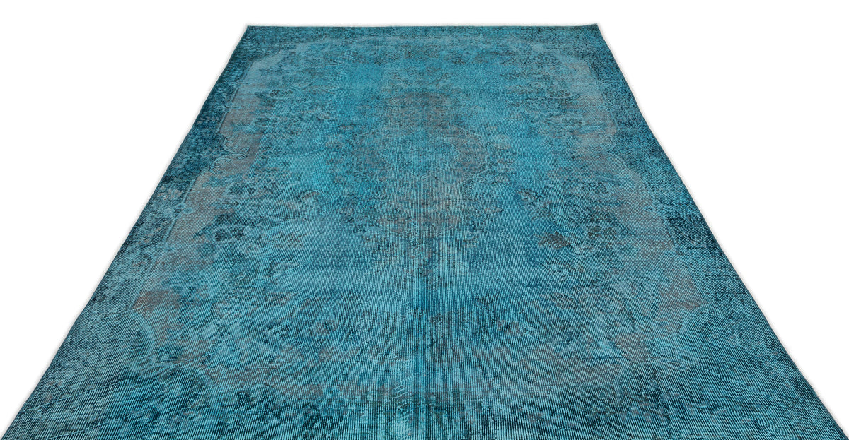 Teal and charcoal distressed traditional rug with a faded central medallion pattern on a white background.