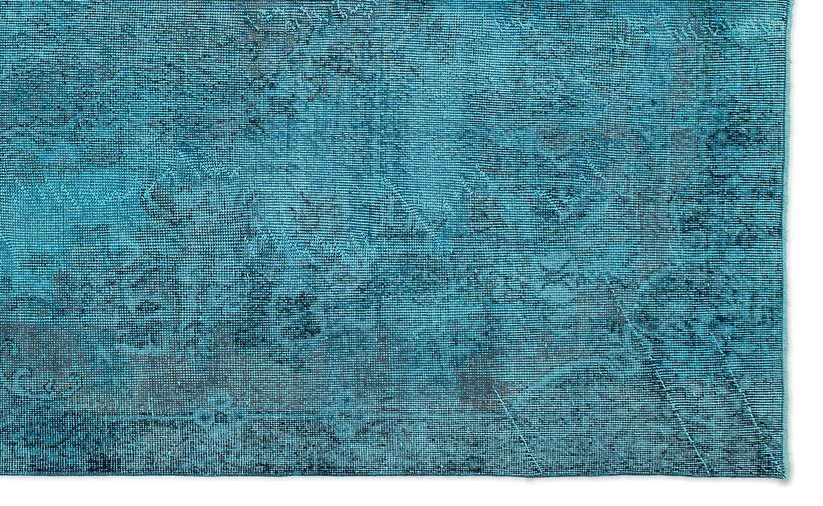 Teal and dark blue distressed rug with a faded, vintage-inspired traditional pattern.