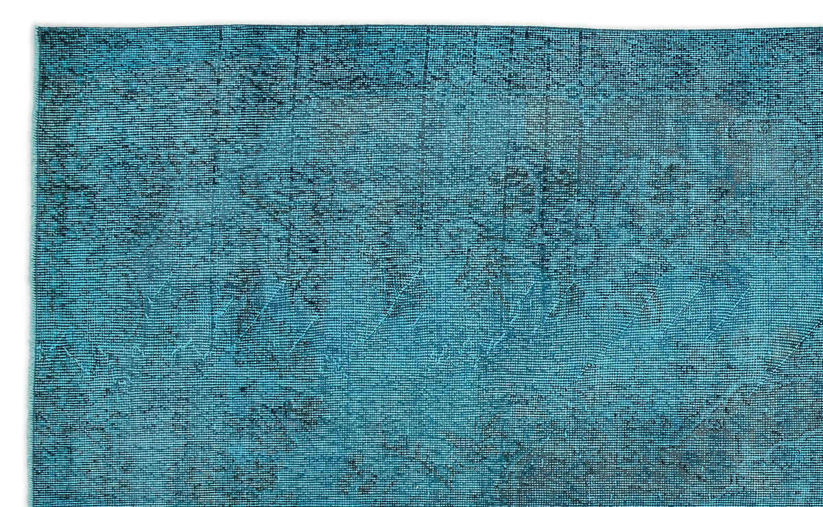 Teal and black distressed rug with a faded traditional medallion pattern on a white background.