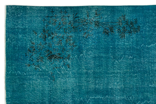 Load image 1 in gallery view. Teal distressed rug with a faded black floral motif and visible woven texture on a white background.