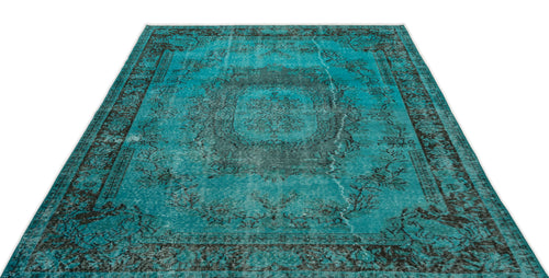Load image 1 in gallery view. Distressed turquoise and black area rug with a traditional central medallion and ornate border pattern.