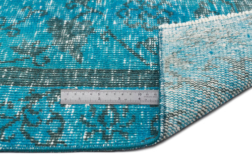 Load image 1 in gallery view. Teal and dark grey distressed medallion rug with a white fringe, shown with a metal ruler for scale.