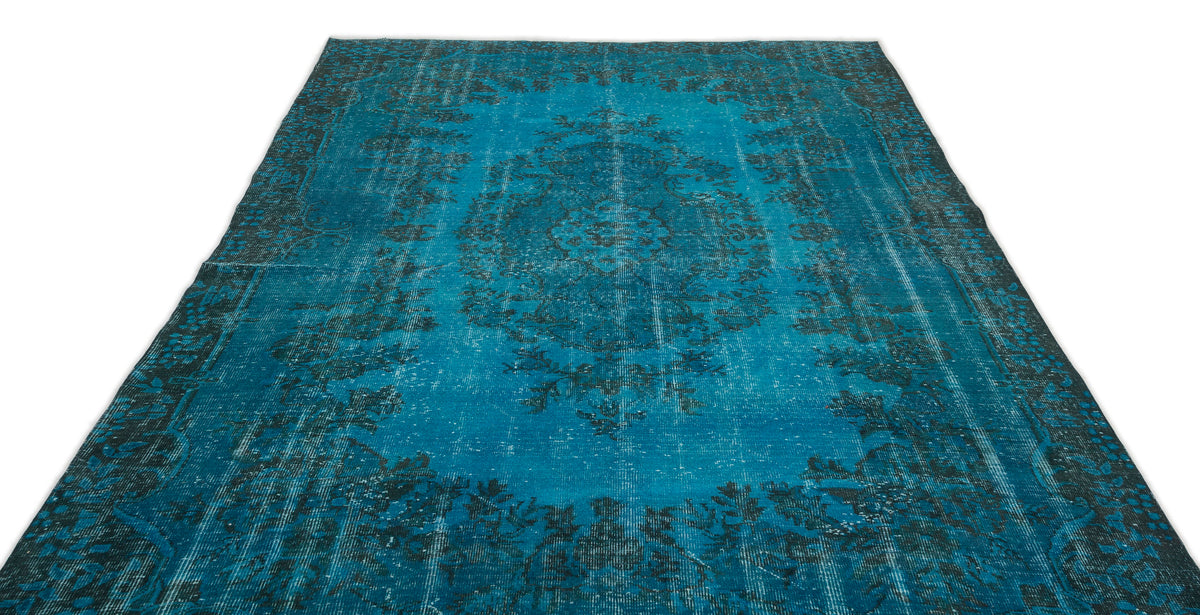 Teal and black distressed rug with a traditional central medallion and ornate border pattern on a white background.
