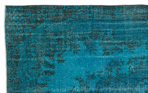 Load image 1 in gallery view. Teal and black distressed rug with a traditional floral border and faded central medallion pattern.