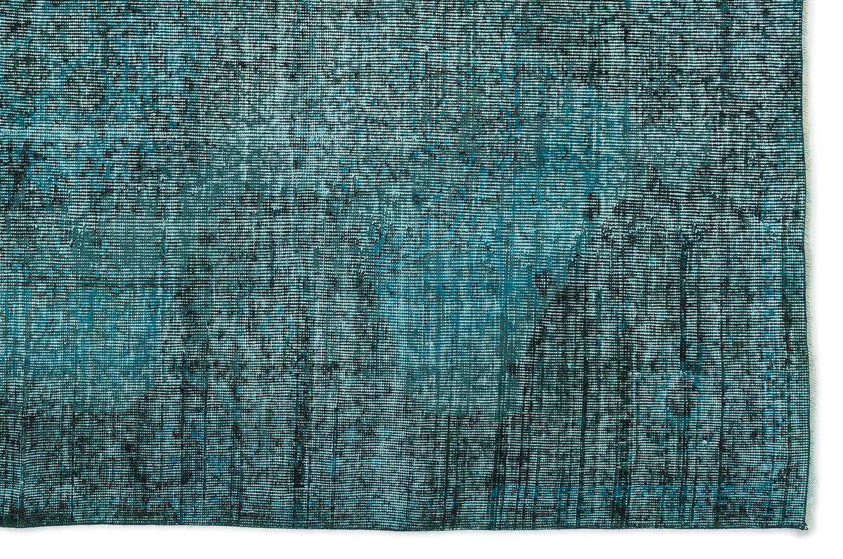 Teal and black distressed rug with a faded, textured horizontal weave pattern.