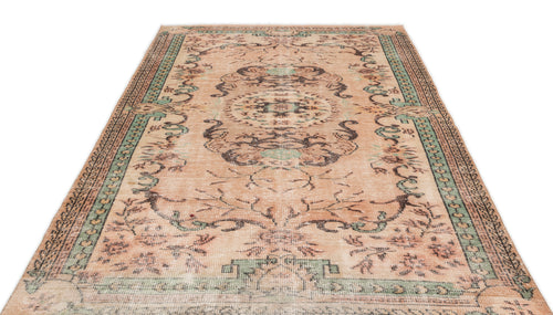 Load image 1 in gallery view. Distressed peach, sage green, and charcoal vintage-style rug with a central floral medallion and ornate border.