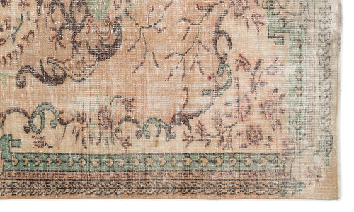 Load image 1 in gallery view. Distressed peach, sage green, and brown rug with a faded traditional floral pattern and geometric border.