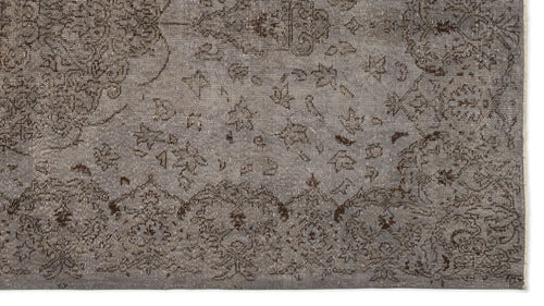 Load image 1 in gallery view. Grey and brown distressed rug with a traditional ornate floral medallion pattern and a fringed edge.