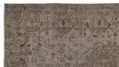 Load image 1 in gallery view. Charcoal grey distressed rug with a faded traditional floral medallion pattern.