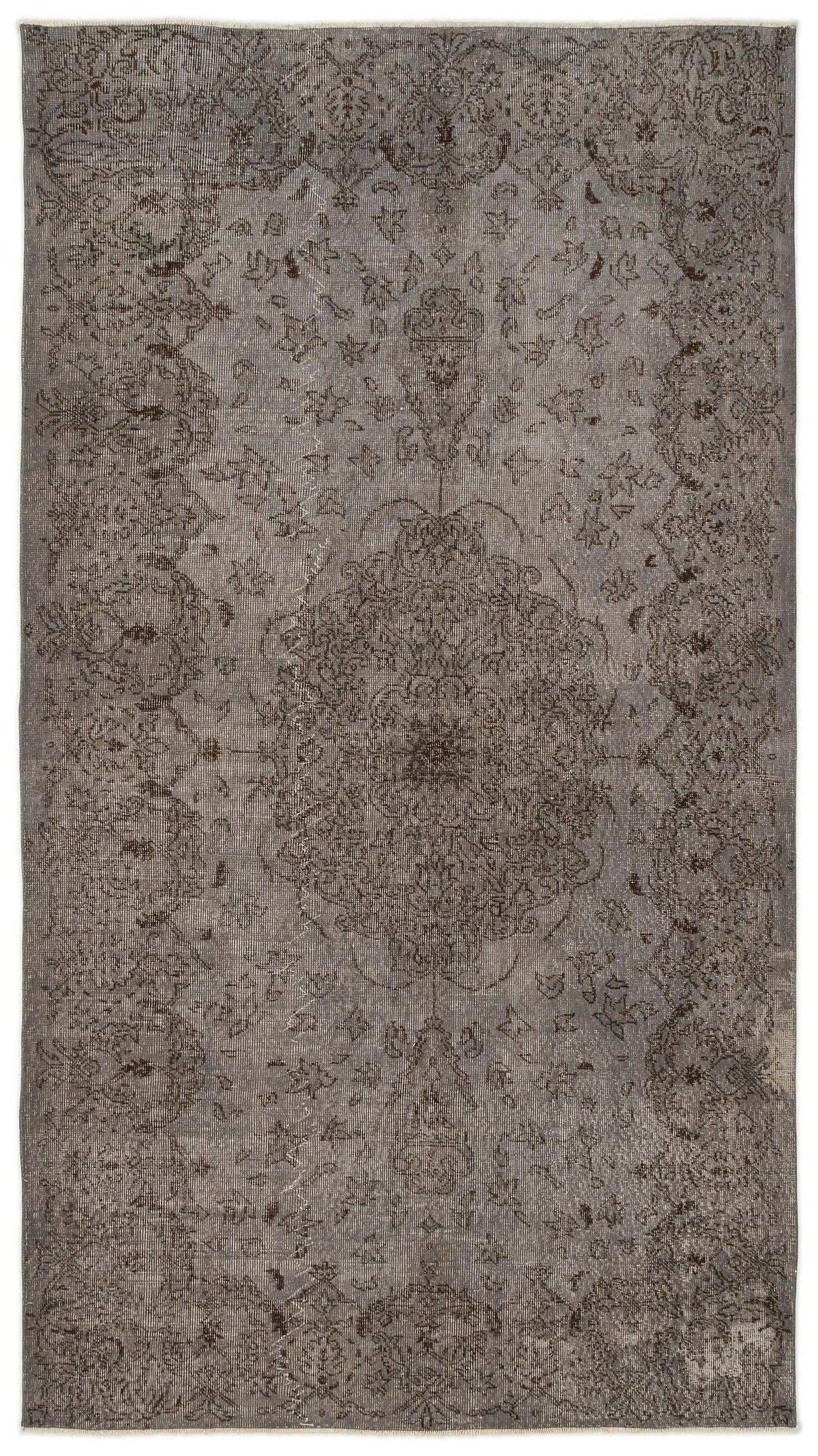 Grey and charcoal distressed rug with a traditional central medallion and ornate floral border pattern.