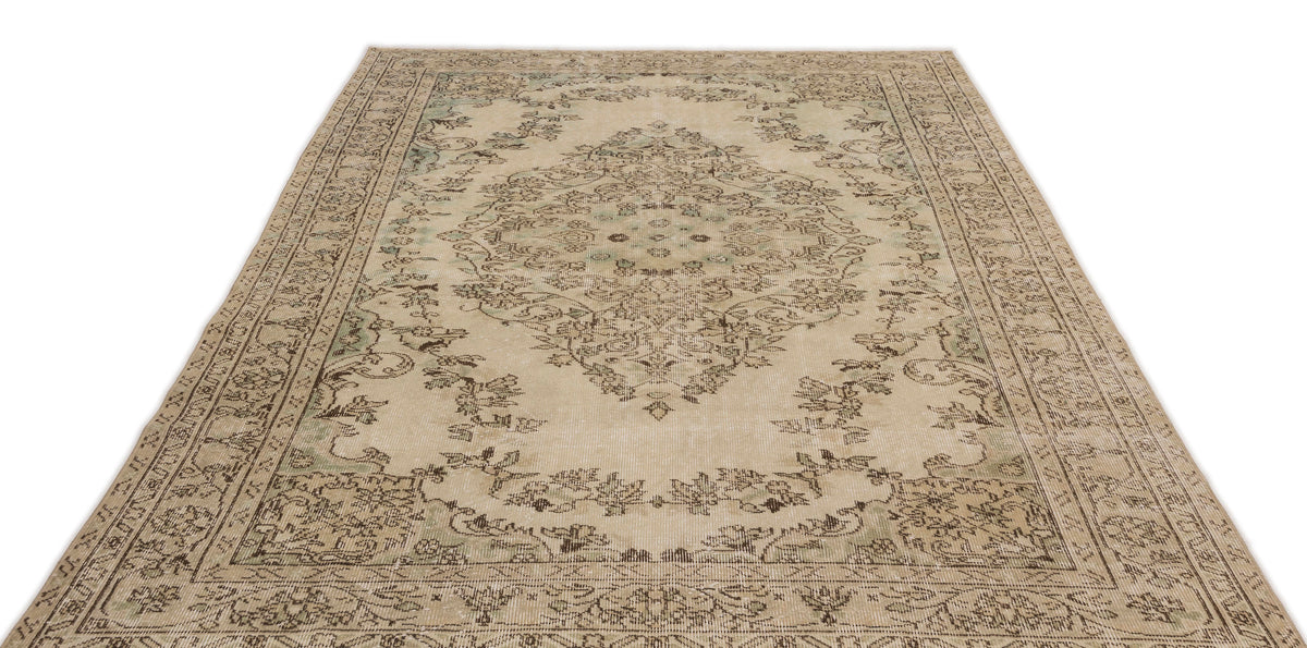 The Mamail Vintage Medallion Rug (6'4" x 9'7") is a rectangular beige rug with an intricate light brown and green floral medallion design and a decorative border on a white background.