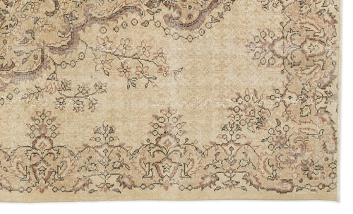 Load image 1 in gallery view. Tan and brown vintage-style rug with a distressed floral medallion pattern and intricate border detail.