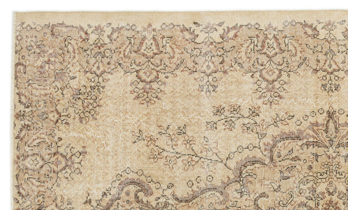Load image 1 in gallery view. Beige and brown vintage-style rug with a distressed floral medallion pattern on a white background.