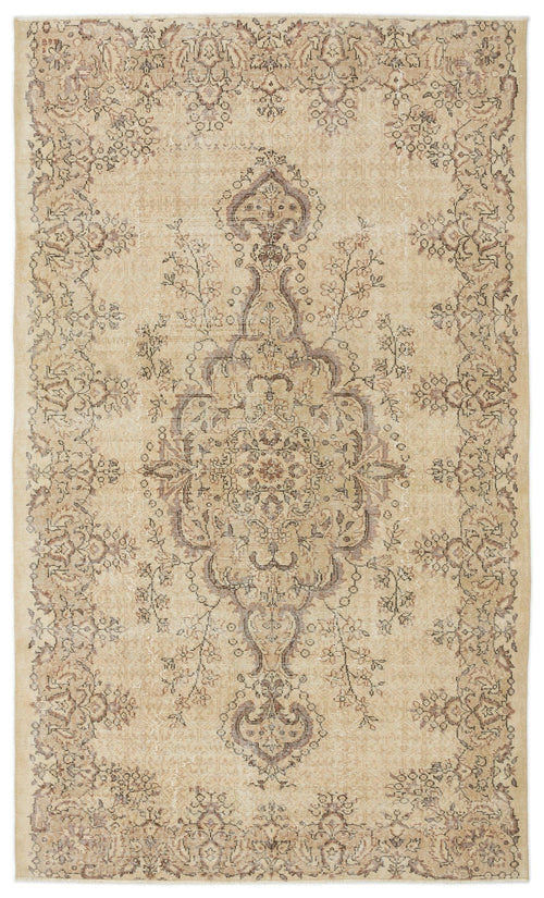 Load image 1 in gallery view. Beige vintage-style rug with a central floral medallion and intricate border in muted brown and charcoal tones.