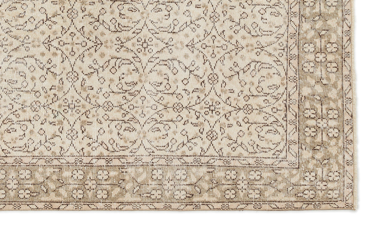The Mofean - Vintage Floral Rug (5'2 x 8'7) features a beige and tan Anatolian hand-woven design with intricate floral and vine patterns, a detailed geometric-floral border, and a slightly distressed vintage look.