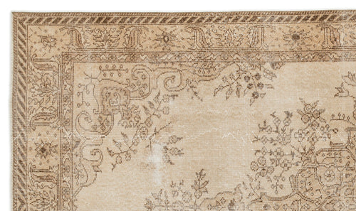 Load image 1 in gallery view. Beige and brown traditional rug with a distressed floral medallion pattern and a striped border.