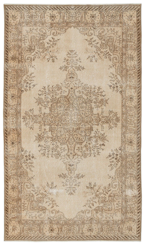 Load image 1 in gallery view. Beige and brown traditional rug with a central floral medallion and a distressed, faded finish.