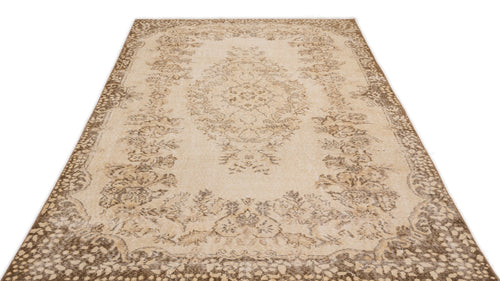Load image 1 in gallery view. Beige and brown vintage-style rug with a central floral medallion and ornate border on a white background.