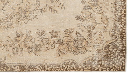 Load image 1 in gallery view. Beige and brown vintage-style rug with a distressed floral medallion pattern and a decorative border.