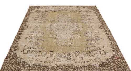 Load image 1 in gallery view. Olive green and brown distressed traditional rug with a central floral medallion and ornate border.